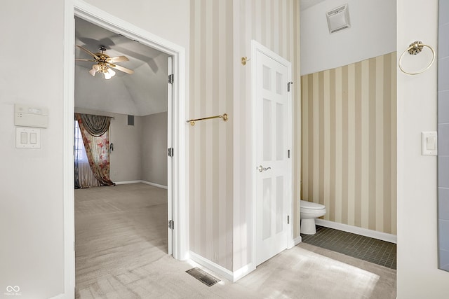 bathroom with baseboards, visible vents, and wallpapered walls