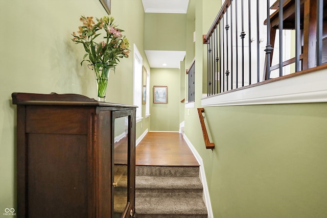 stairs featuring baseboards and wood finished floors