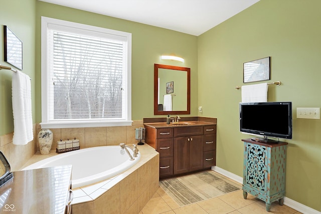 bathroom with a wealth of natural light, vanity, a bath, and tile patterned floors