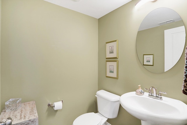 bathroom featuring visible vents, a sink, and toilet