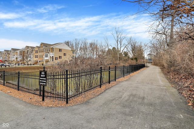 surrounding community with fence and a residential view