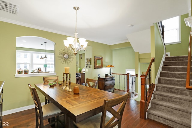 dining space featuring baseboards, crown molding, visible vents, and hardwood / wood-style floors