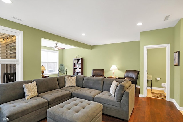 living room with baseboards, dark wood-style flooring, visible vents, and recessed lighting