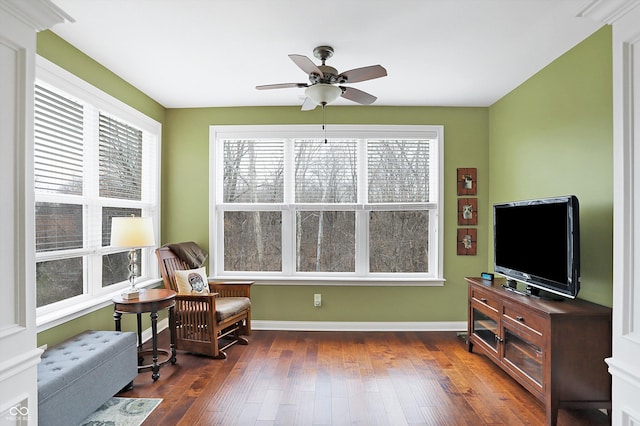 sitting room with ceiling fan, dark wood-style flooring, and baseboards