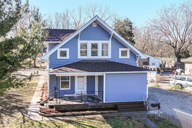 view of front of property featuring covered porch and roof with shingles