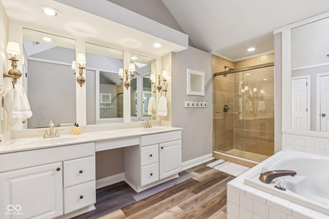 bathroom with lofted ceiling, a stall shower, a sink, and a bath