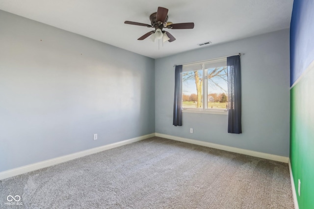 unfurnished room with carpet, visible vents, ceiling fan, and baseboards