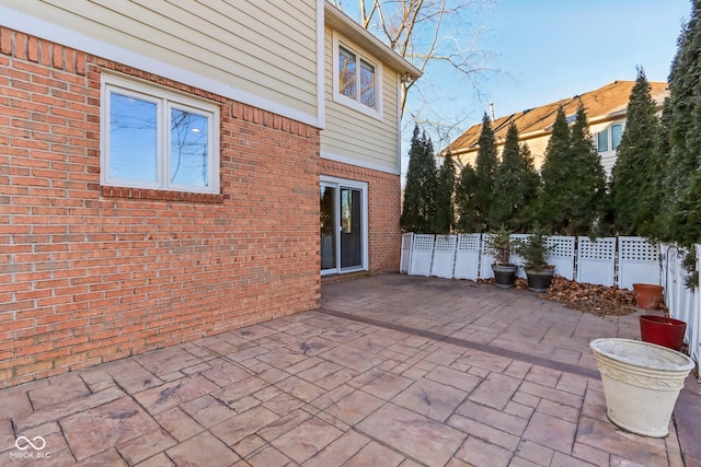 view of patio featuring fence