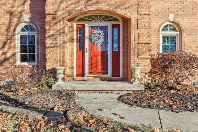 doorway to property featuring crawl space and brick siding