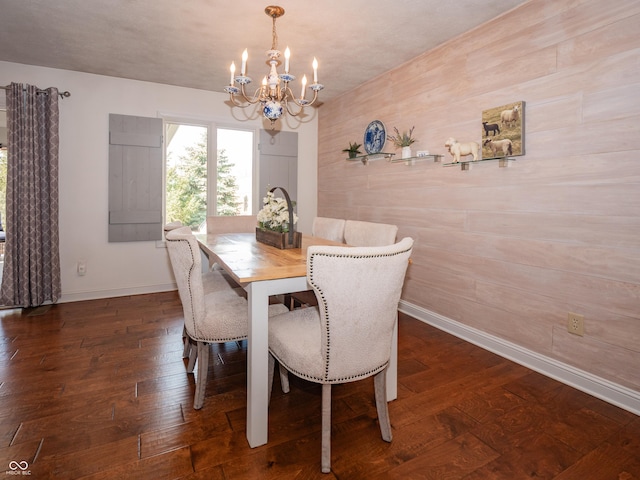 dining area with a notable chandelier, wood-type flooring, and baseboards