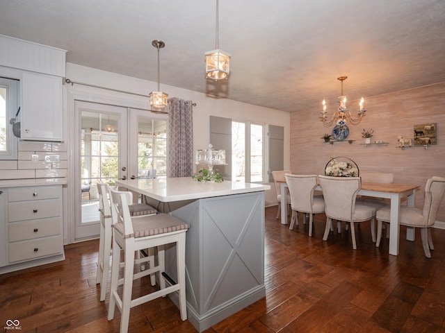 kitchen with dark wood-style floors, white cabinetry, light countertops, and french doors