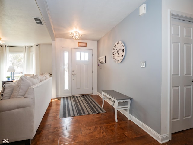 entrance foyer with visible vents, baseboards, and hardwood / wood-style flooring