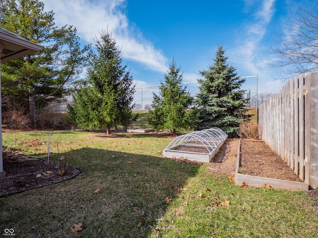 view of yard with a vegetable garden and fence