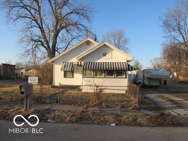 bungalow-style home featuring fence