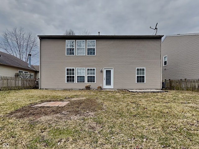 back of house with a yard, a patio, and fence