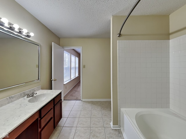 full bath featuring a textured ceiling, tile patterned flooring, vanity, baseboards, and  shower combination