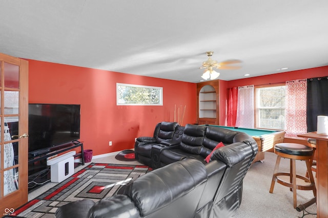 living area featuring baseboards, carpet, ceiling fan, and billiards