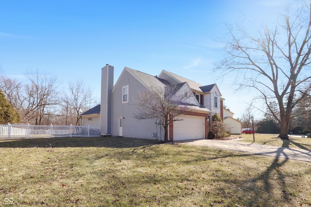 view of home's exterior featuring a lawn, driveway, a chimney, and fence