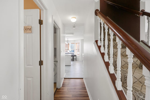 hall featuring stairs, baseboards, and wood finished floors