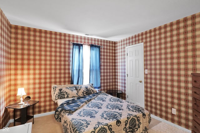 bedroom with wallpapered walls and baseboards