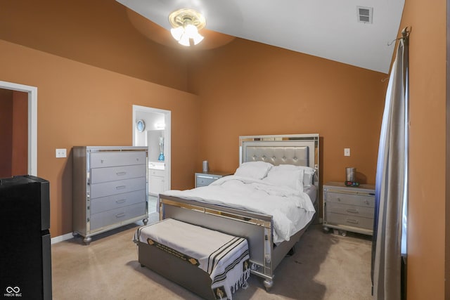 bedroom featuring visible vents, ensuite bathroom, a ceiling fan, lofted ceiling, and light colored carpet