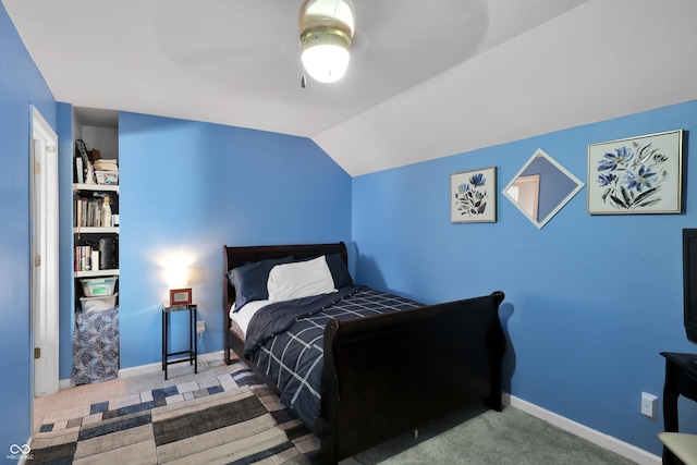 carpeted bedroom with baseboards, a ceiling fan, and vaulted ceiling