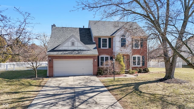 view of front of property with a front lawn, an attached garage, and fence