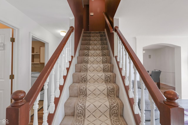 stairway featuring arched walkways