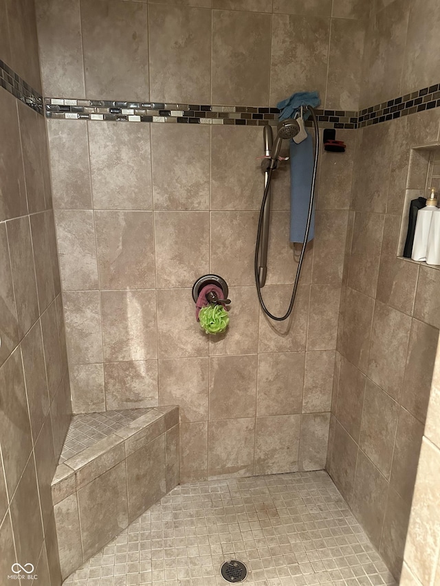 bathroom with a tile shower