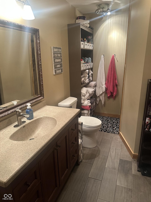 full bath featuring toilet, walk in shower, and vanity