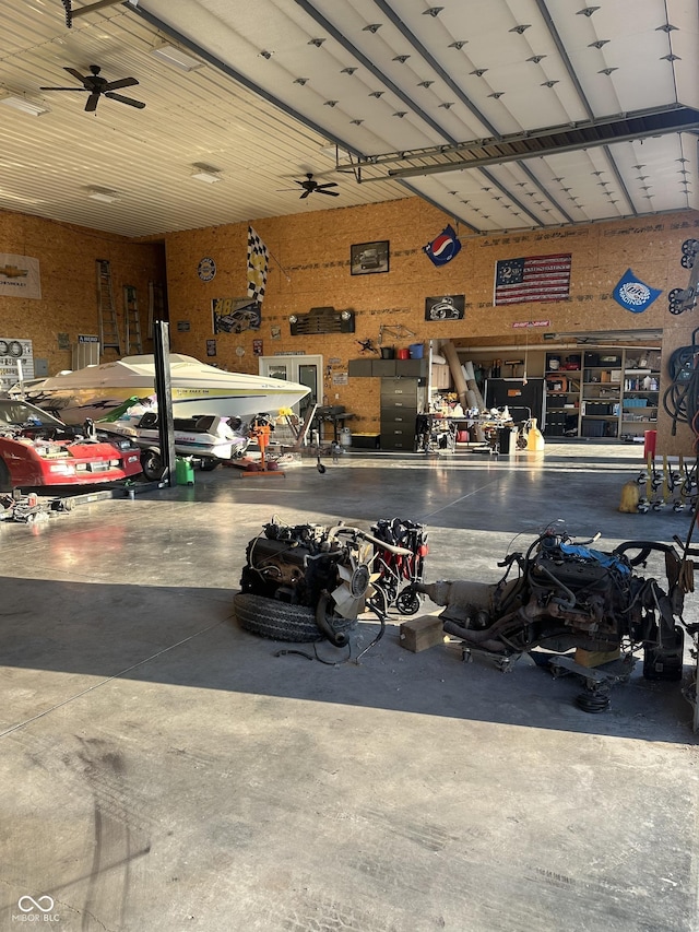 garage with ceiling fan and a workshop area