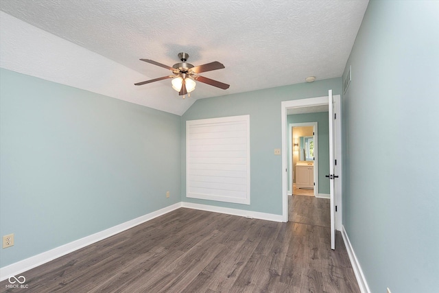 unfurnished bedroom featuring dark wood-style floors, baseboards, and a textured ceiling