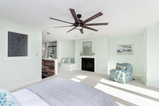 bedroom with a textured ceiling, a fireplace, carpet flooring, and baseboards