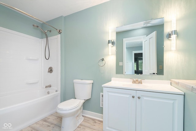 bathroom featuring toilet, shower / bath combination, wood finished floors, vanity, and baseboards