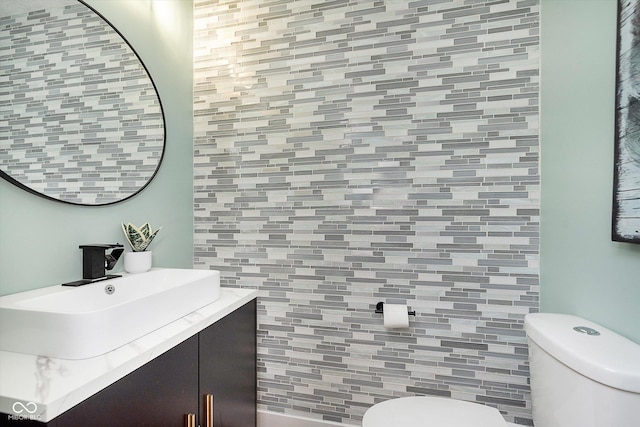 half bathroom featuring toilet and vanity