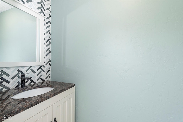 bathroom featuring tasteful backsplash and vanity