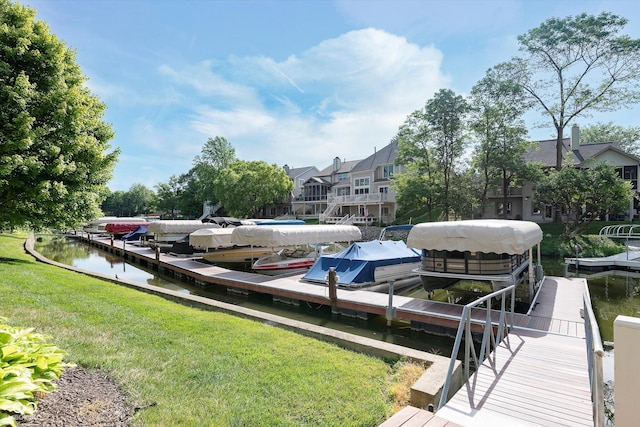 view of dock with a water view and a yard