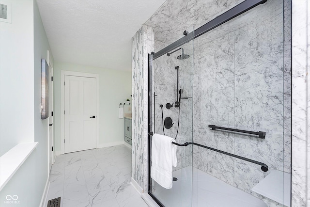 full bathroom featuring marble finish floor, baseboards, visible vents, and a stall shower