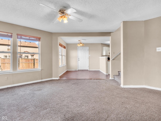 interior space featuring ceiling fan, stairway, carpet, and baseboards