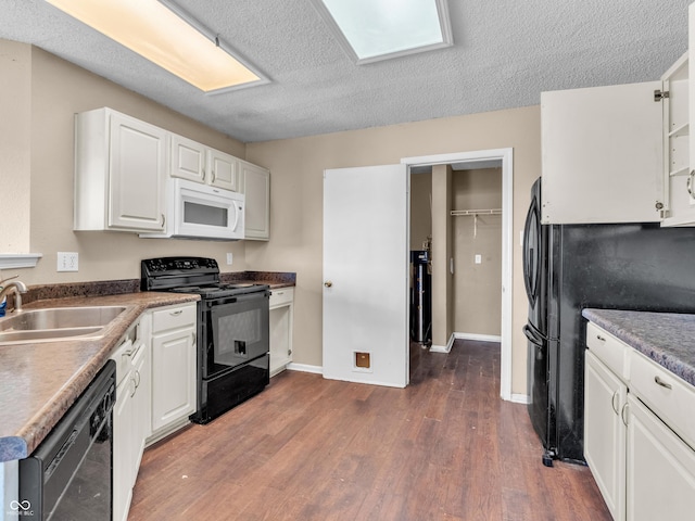 kitchen with dark wood-style flooring, white cabinets, a sink, and black appliances