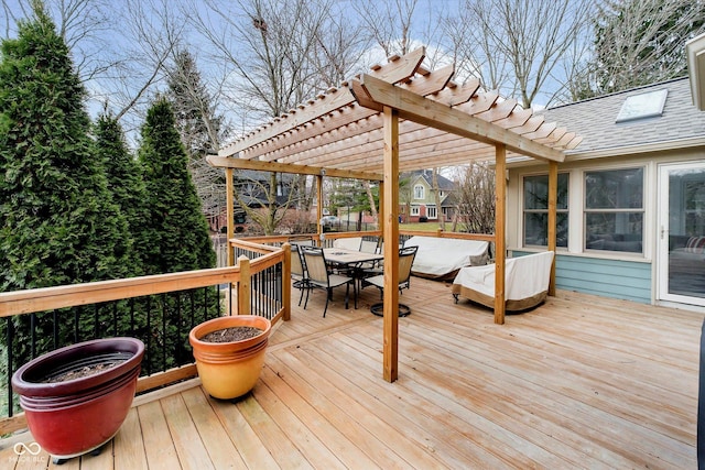 wooden terrace featuring outdoor dining area and a pergola