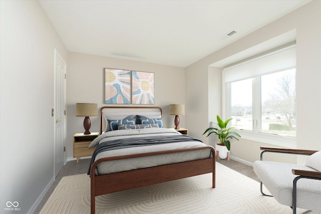 carpeted bedroom with visible vents and baseboards