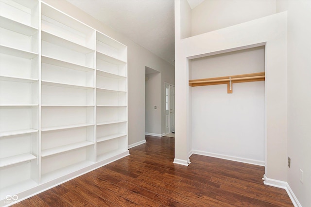 interior space featuring dark wood-style floors, a closet, and baseboards