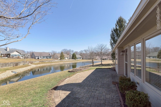 view of patio featuring a residential view and a water view