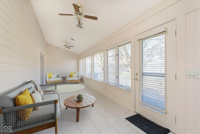 sunroom / solarium with a healthy amount of sunlight, lofted ceiling, and a ceiling fan