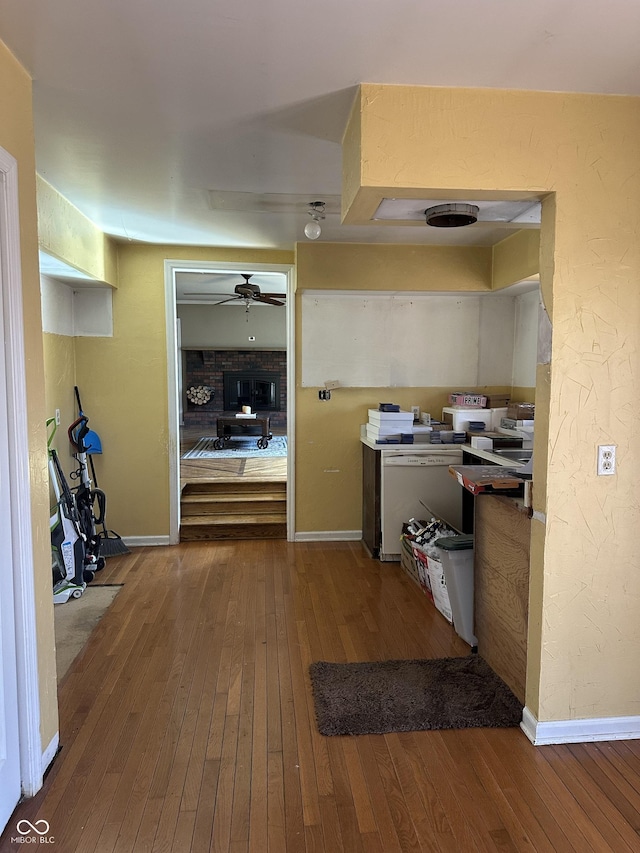 kitchen with ceiling fan, wood-type flooring, and baseboards