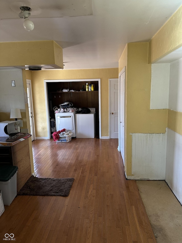 hallway with washer and dryer and hardwood / wood-style floors