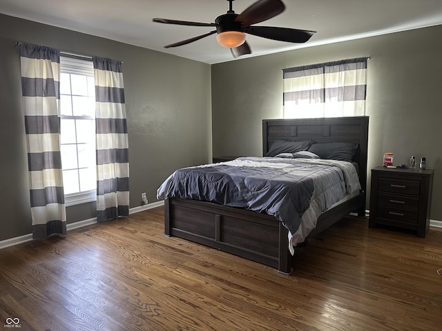 bedroom with ceiling fan, baseboards, and wood finished floors