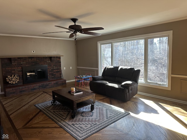 living room featuring a wealth of natural light, a brick fireplace, and crown molding