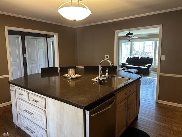 kitchen featuring ornamental molding, dark wood finished floors, dishwasher, and a sink